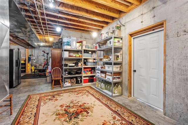 basement with stainless steel fridge