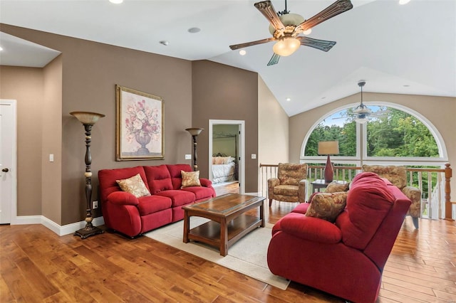 living room with light hardwood / wood-style flooring, high vaulted ceiling, and ceiling fan