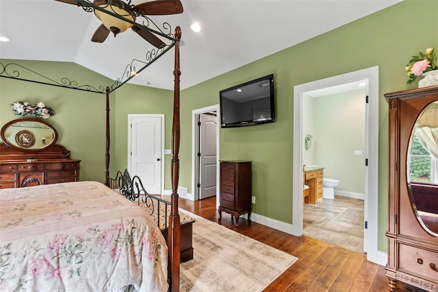 tiled bedroom featuring connected bathroom, ceiling fan, and vaulted ceiling