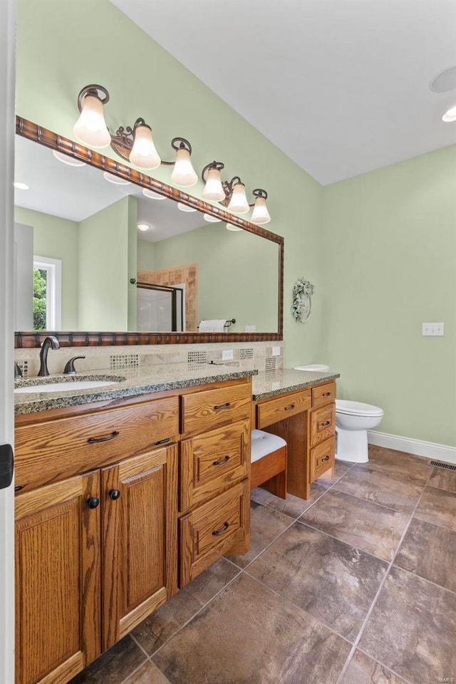 bathroom with vanity, backsplash, tile patterned flooring, and toilet