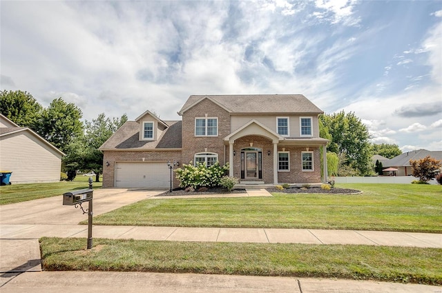 view of front of property featuring a front yard and a garage