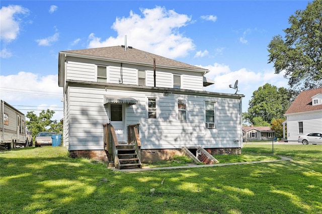 rear view of house featuring a yard