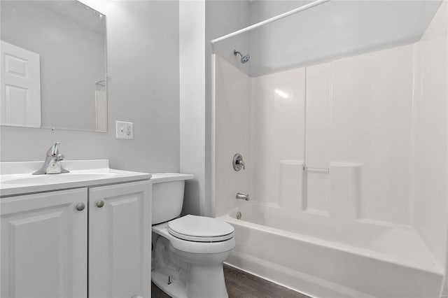 full bathroom featuring vanity, toilet, wood-type flooring, and shower / tub combination