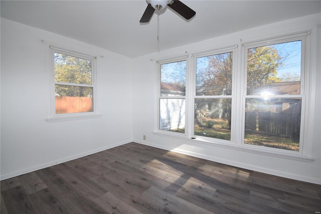 spare room with ceiling fan and dark hardwood / wood-style floors