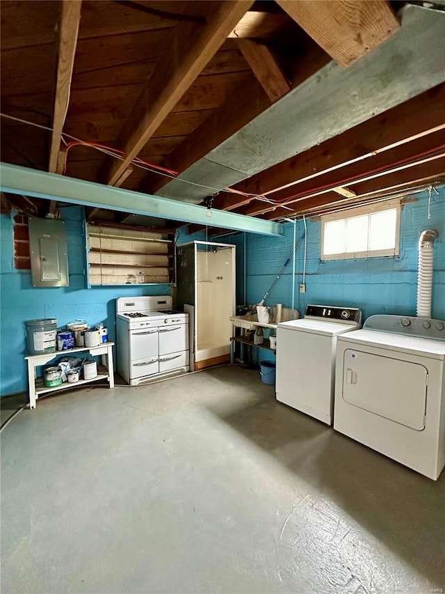 basement featuring electric panel and washer and dryer