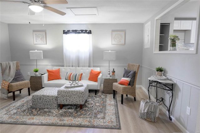 living room with ceiling fan and light wood-type flooring