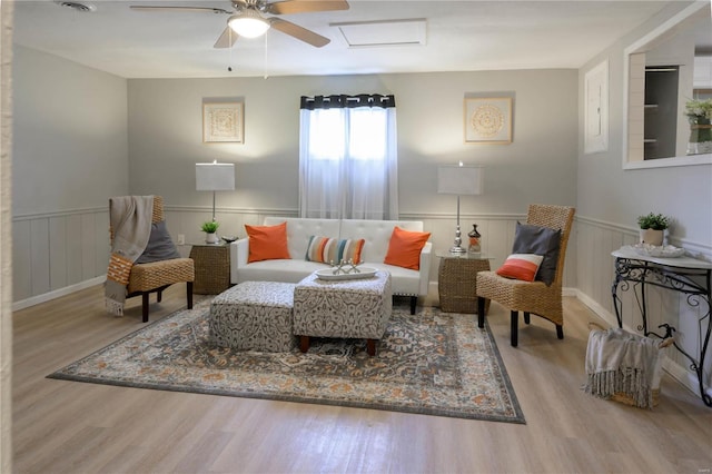 living room featuring light wood-type flooring and ceiling fan