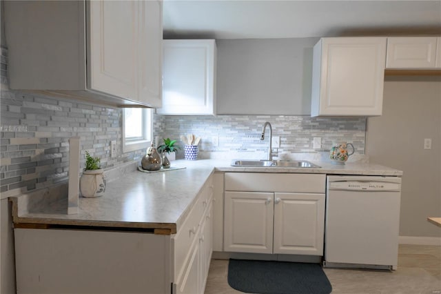 kitchen featuring sink, white dishwasher, and decorative backsplash