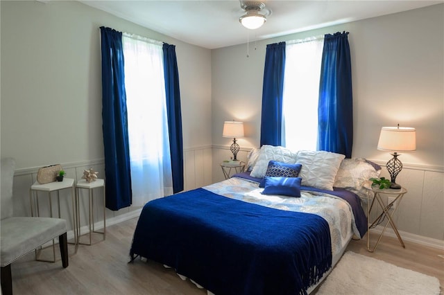 bedroom with ceiling fan and light hardwood / wood-style floors