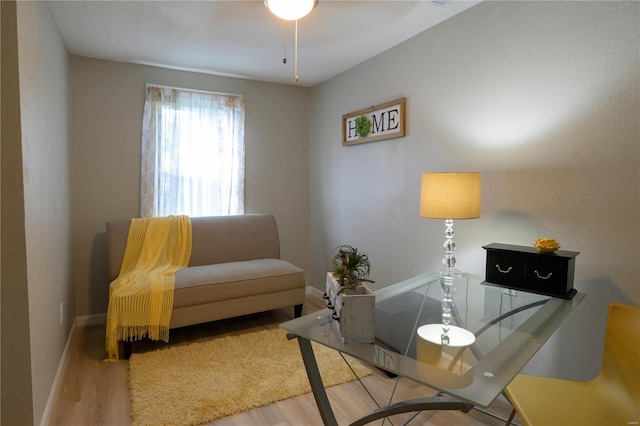 living room featuring ceiling fan and light wood-type flooring