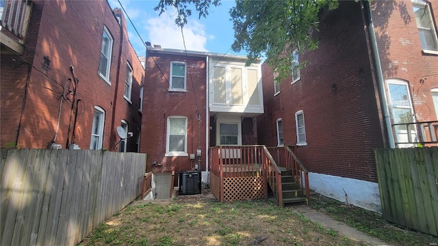 rear view of house featuring central AC