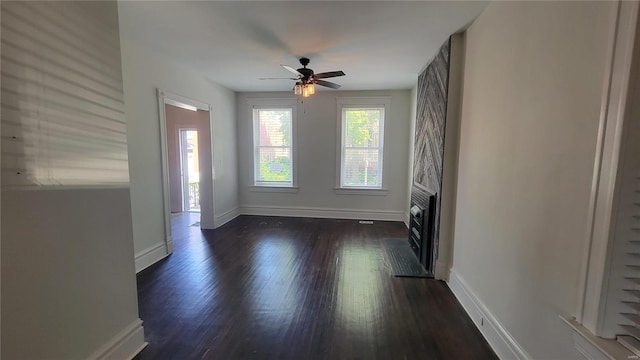 unfurnished room with ceiling fan and dark hardwood / wood-style floors