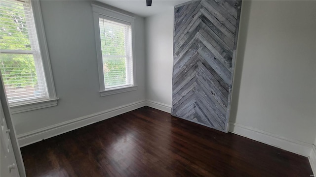 empty room featuring dark hardwood / wood-style floors and a healthy amount of sunlight