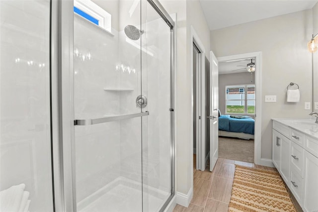 bathroom featuring vanity, an enclosed shower, and ceiling fan