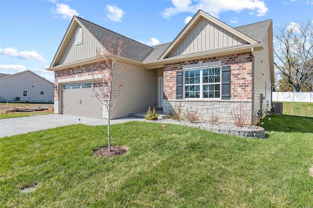 view of front of property with a garage, central air condition unit, and a front lawn