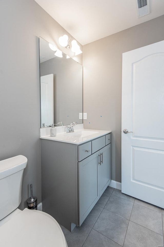 bathroom featuring vanity, toilet, and tile patterned flooring