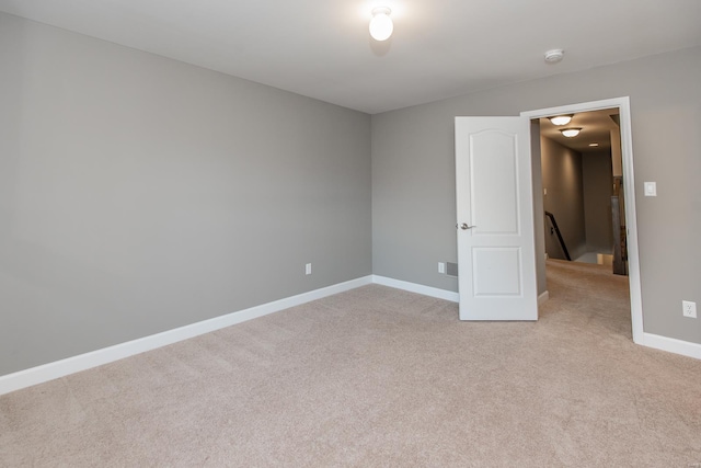 unfurnished room with light carpet