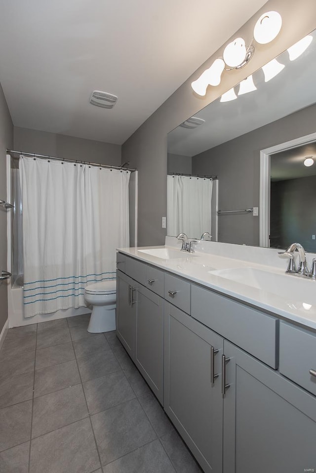 bathroom with walk in shower, vanity, toilet, and tile patterned flooring