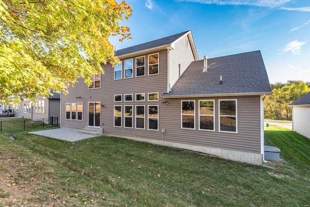 back of property featuring a patio area and a lawn