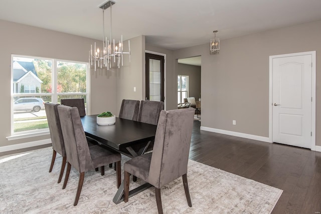 dining space with an inviting chandelier and dark wood-type flooring