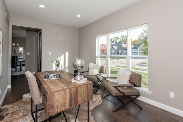 dining space featuring a notable chandelier, dark hardwood / wood-style floors, and plenty of natural light