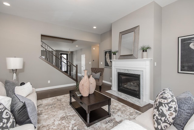 living room featuring dark hardwood / wood-style floors and a high end fireplace