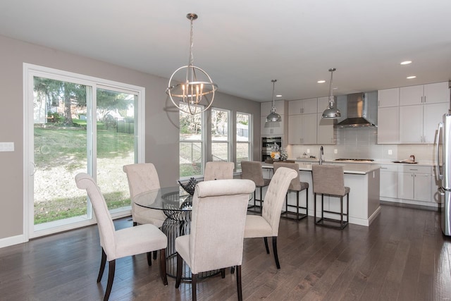 dining area with dark hardwood / wood-style flooring, plenty of natural light, and an inviting chandelier