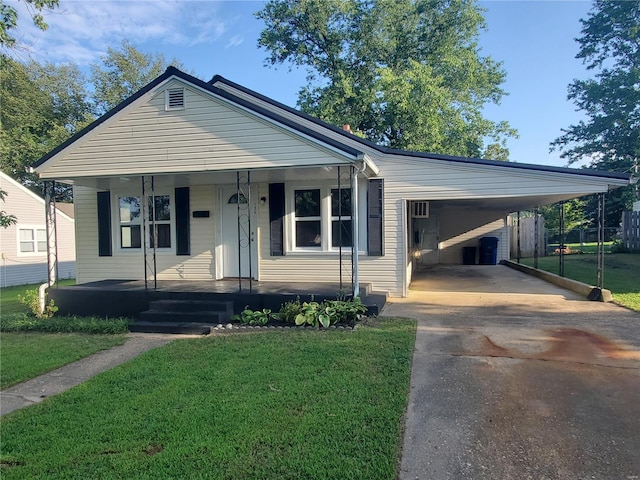 view of front facade with a carport and a front yard