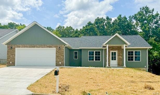 view of front of property featuring a garage and a front lawn