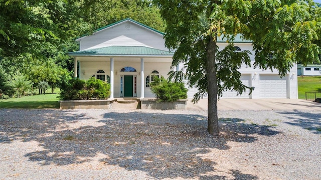 view of front facade with covered porch and a garage