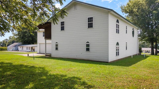 rear view of house featuring a yard