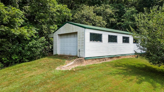 view of outbuilding featuring a garage and a lawn