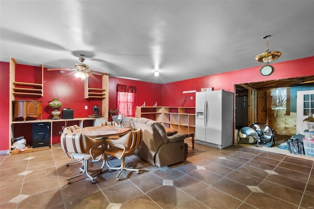 tiled dining space featuring ceiling fan