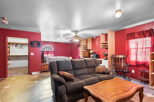 tiled living room with ceiling fan