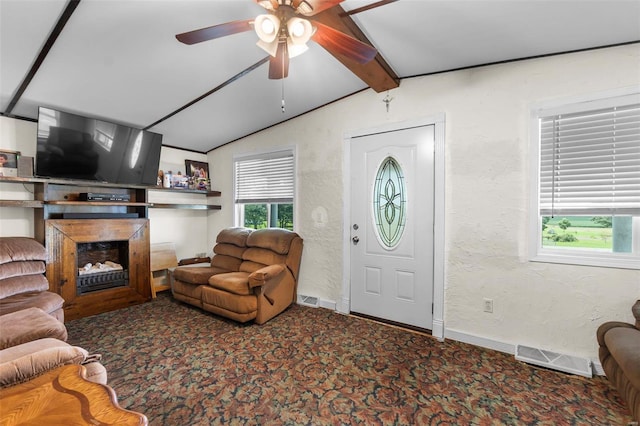 carpeted living room featuring ceiling fan and vaulted ceiling