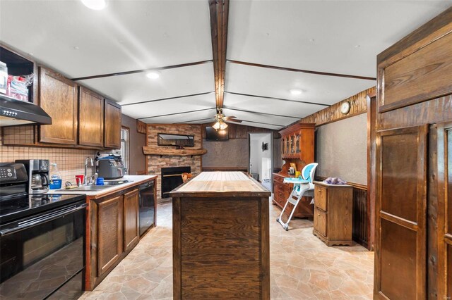 kitchen with a fireplace, ceiling fan, vaulted ceiling with beams, a kitchen island, and black range with electric stovetop