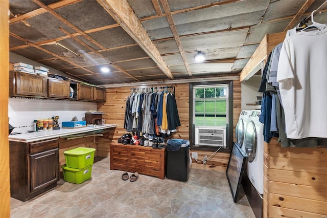 interior space featuring washing machine and dryer and wooden walls