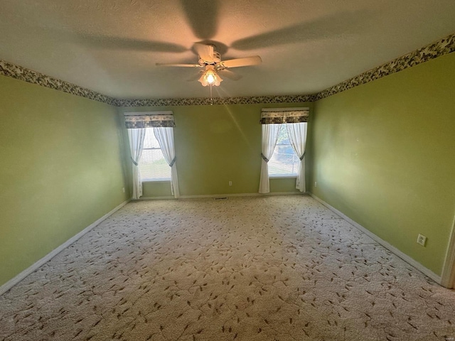 empty room with carpet, a textured ceiling, and ceiling fan