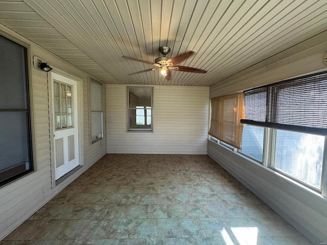 unfurnished sunroom with ceiling fan and wood ceiling