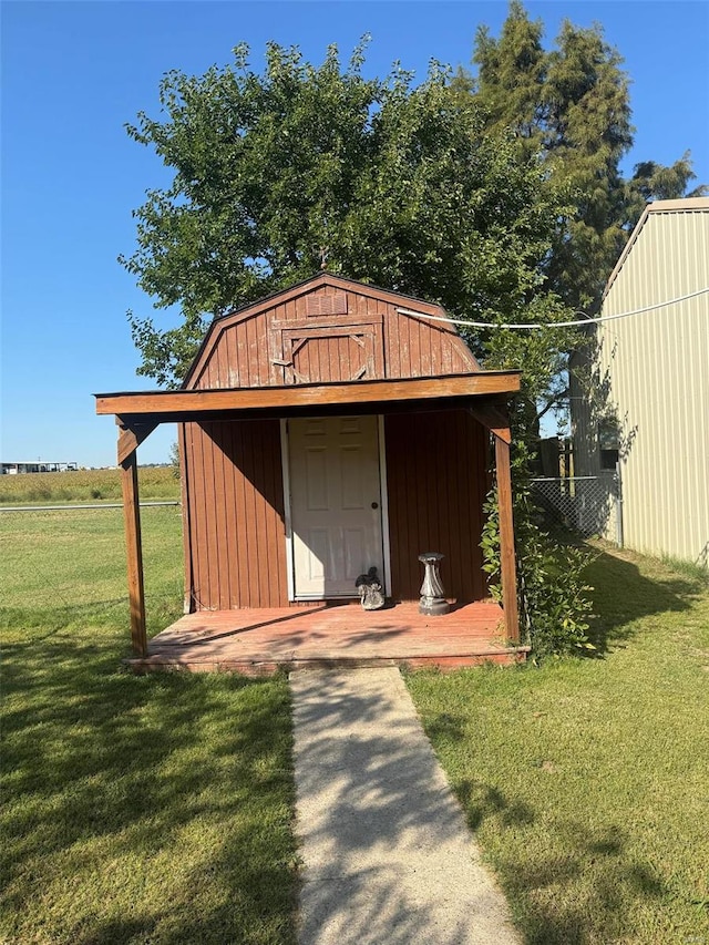 view of outbuilding featuring a lawn