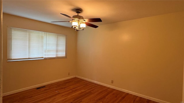 unfurnished room with ceiling fan and hardwood / wood-style floors