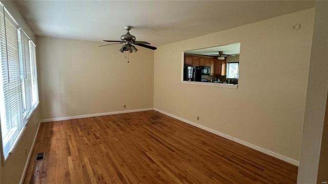 unfurnished room with ceiling fan and hardwood / wood-style flooring