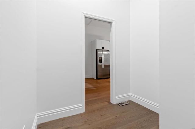 hallway with light hardwood / wood-style flooring