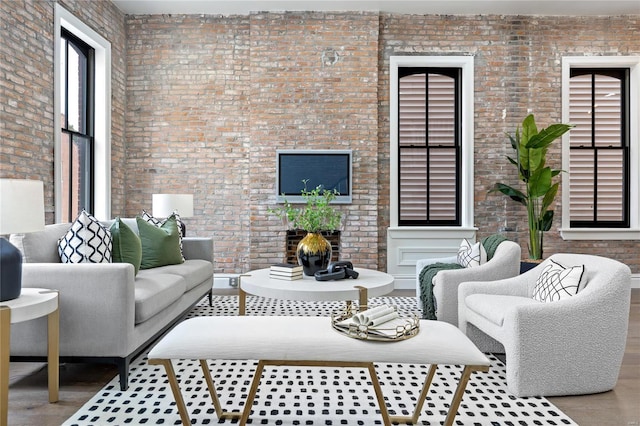 living room with brick wall and concrete floors