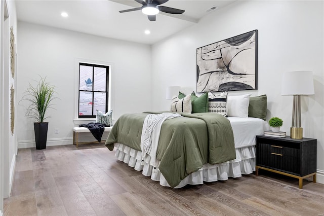 bedroom with wood-type flooring and ceiling fan