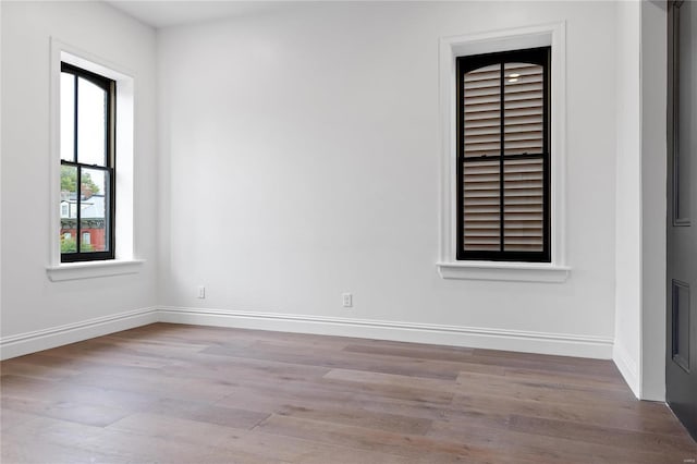 unfurnished room with light hardwood / wood-style floors