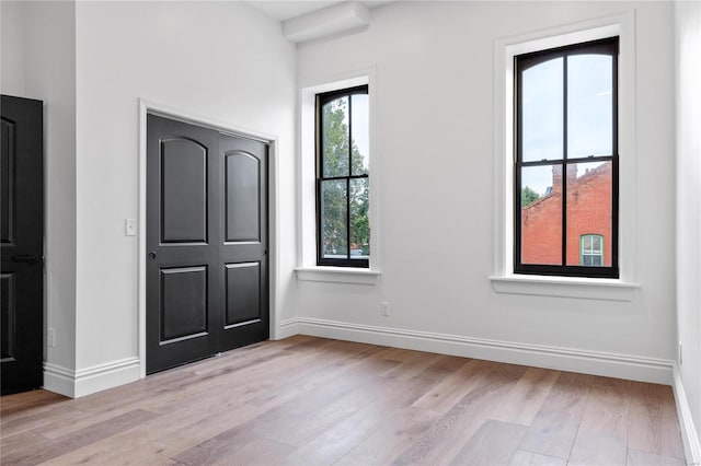 unfurnished bedroom featuring light wood-type flooring