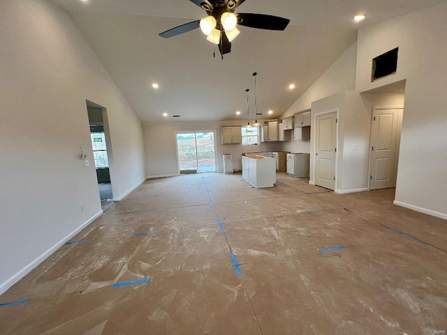 unfurnished living room featuring ceiling fan and high vaulted ceiling