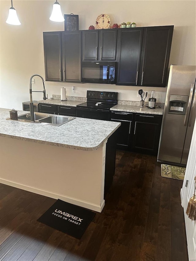 kitchen featuring pendant lighting, black appliances, dark hardwood / wood-style floors, and sink