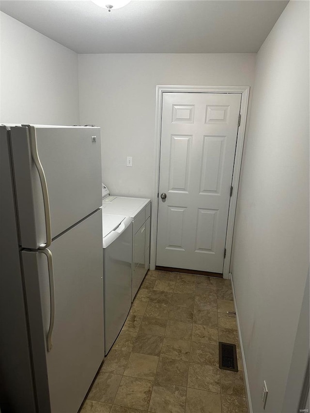 washroom with independent washer and dryer